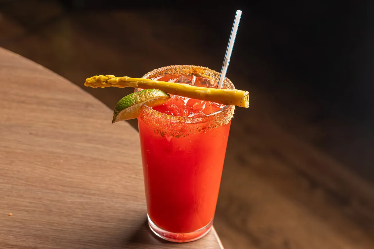 A Caesar with a salted rim, lime and a pickled bean